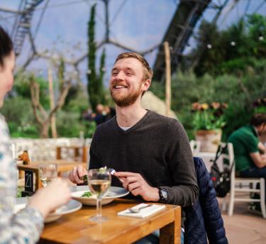 Couple enjoying food and drinks in our Med Terrace